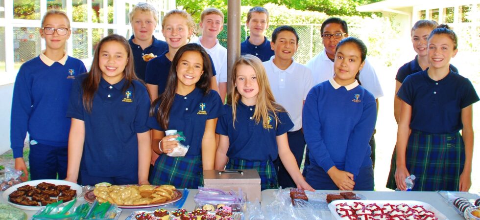 children standing by the bake sale table