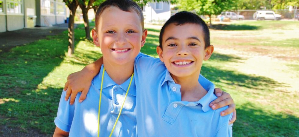 two happy students smiling