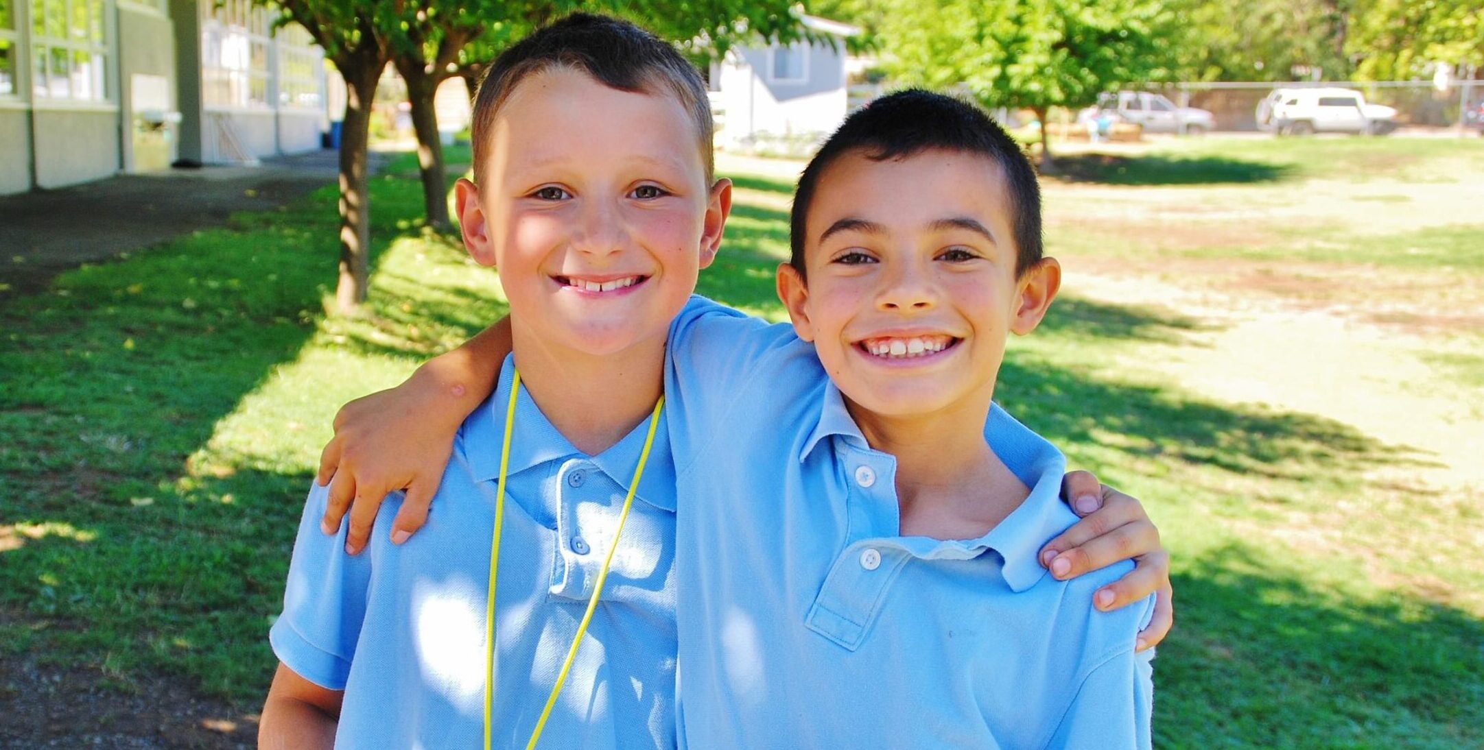 two happy students smiling