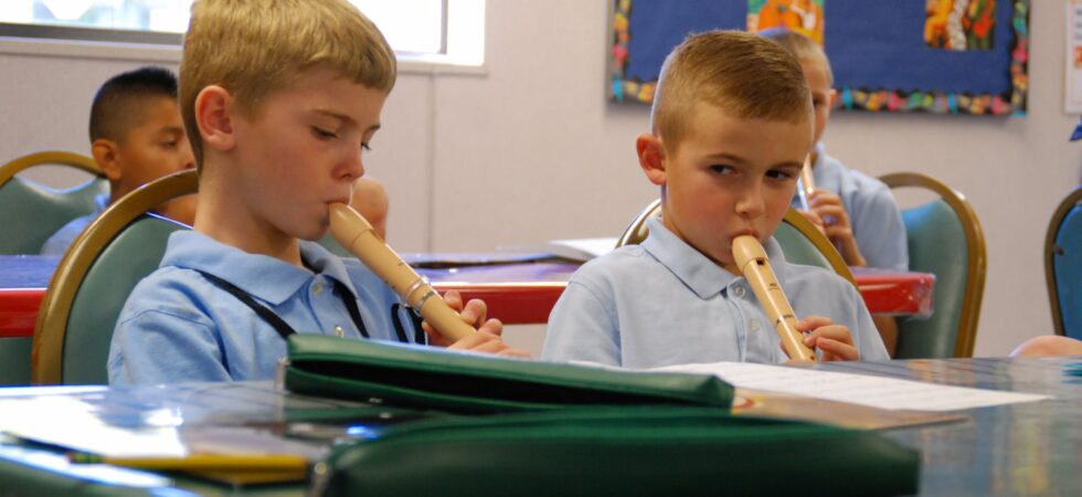 Children playing the recorder during music class
