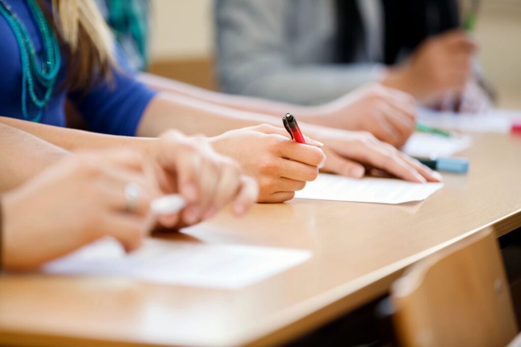 Photo of student hands doing schoolwork